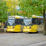 Two Metrolink trams parked at Piccadilly Stations tram stop