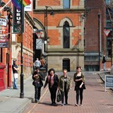 4 women walking down Canal Street, Manchester