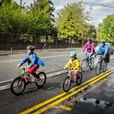 Family cycling along the Wilmslow road cycleway