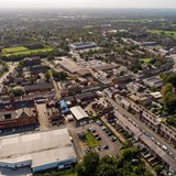 Aerial view of roads, and residential and commercial buildings in Westhoughton