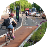 People cycling on a cycle path on Oxford Road, Manchester